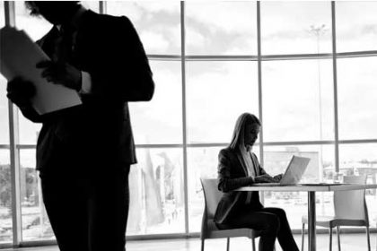 A businesswoman uses a laptop in an office, highlighting concerns around vet funding.