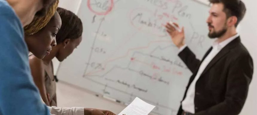 A team collaborates on a marketing plan, highlighting key aspects of vet compliance.